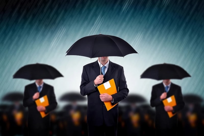 A group of businessmen in suits holding black umbrellas and orange folders against a rainy blue background, with the central figure in sharp focus.