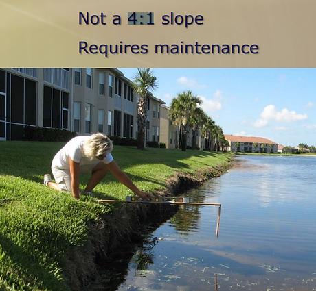 A person uses a level and measuring tool to inspect a steep, eroded grassy shoreline by a pond, with text overlay stating "Not a 4:1 slope, Requires maintenance."